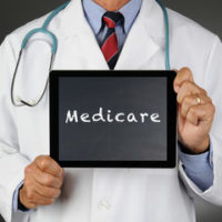 Dr. holding a Medicare sign
