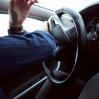 Image of a person driving a car, representing the dangers drivers and passengers face and how the West Virginia car accident attorneys at Burke, Schultz, Harman & Jenkinson can help victims of auto accidents.
