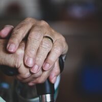 Hands of an elderly person, representing how a West Virginia nursing home abuse attorney can help victims and their families.